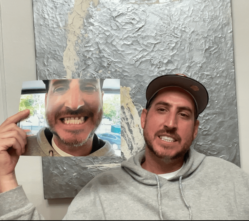 Person in hoodie with a photo